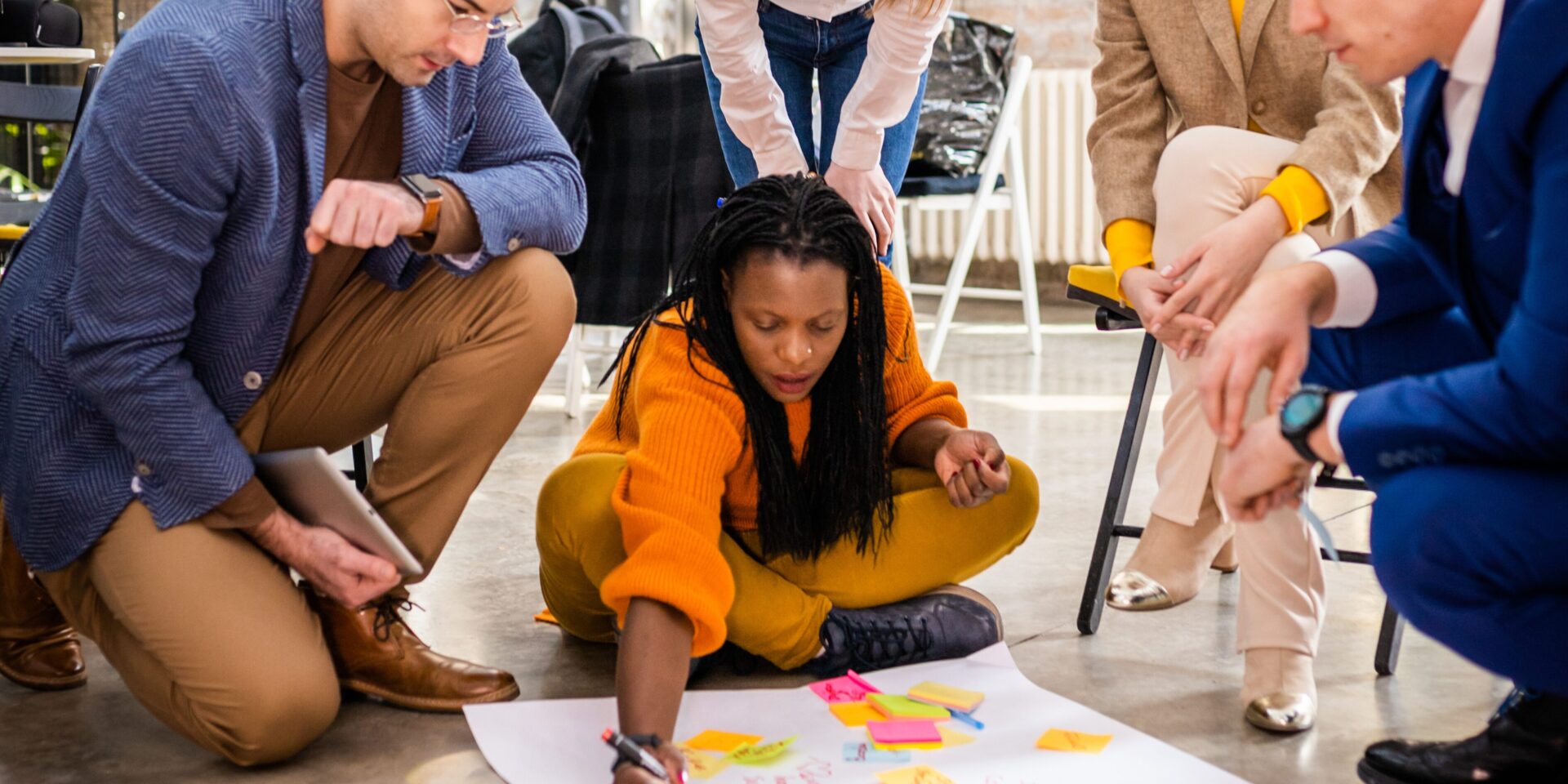 A start-up team working together in a modern office, symbolising the importance of business insurance for new businesses.