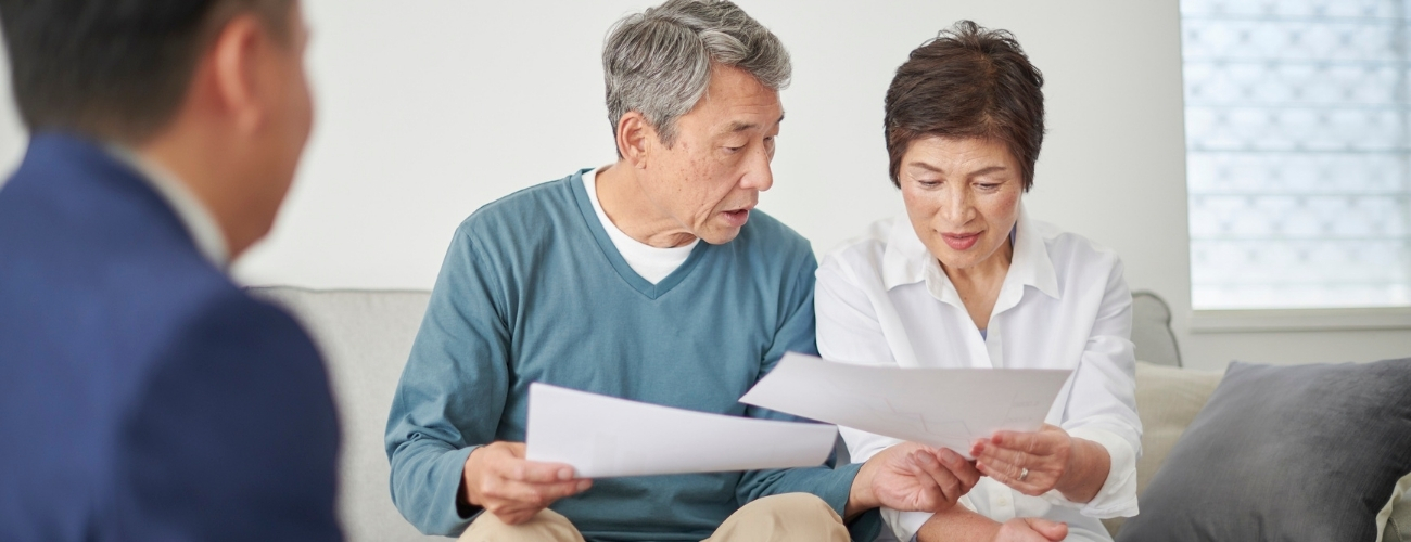 Couple reviewing property documents and financial analysis together